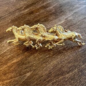 Vintage brass barrette, 4 inches long featuring four horses